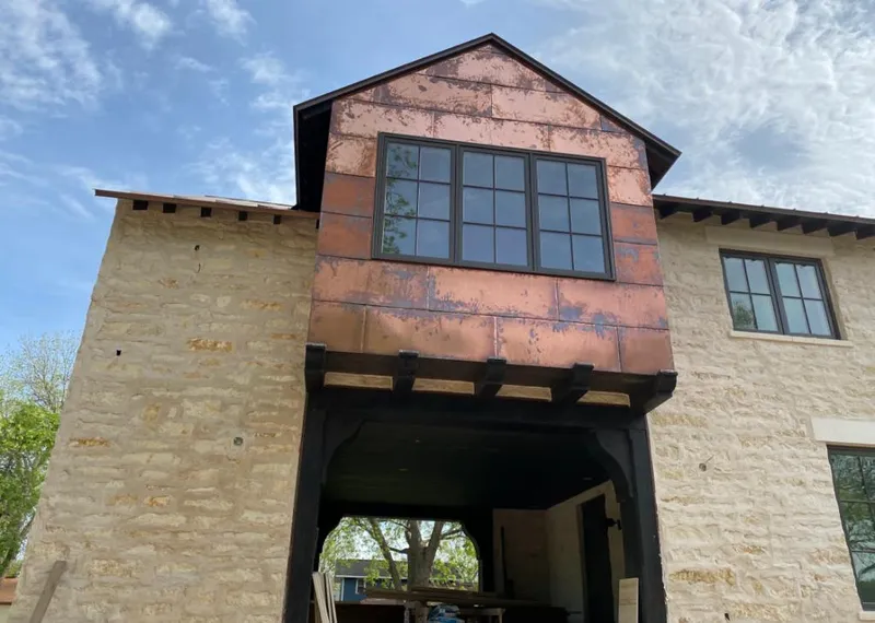Copper metal panel facade on a stone building for Roof Repair in El Dorado